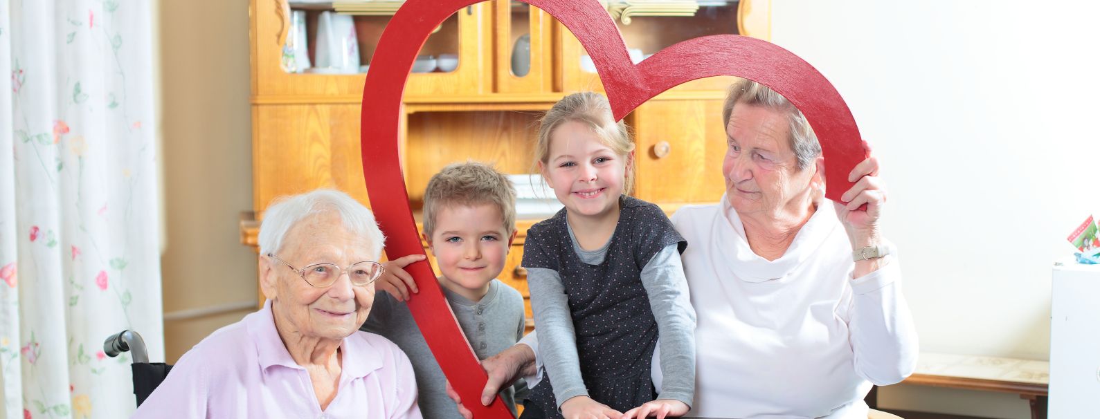 ältere Damen mit Kindern und Herz-Bogen